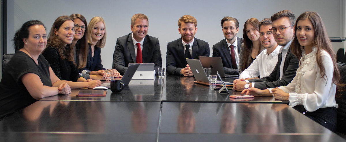 The team of the Chair of Marketing gathered at a conference table seated